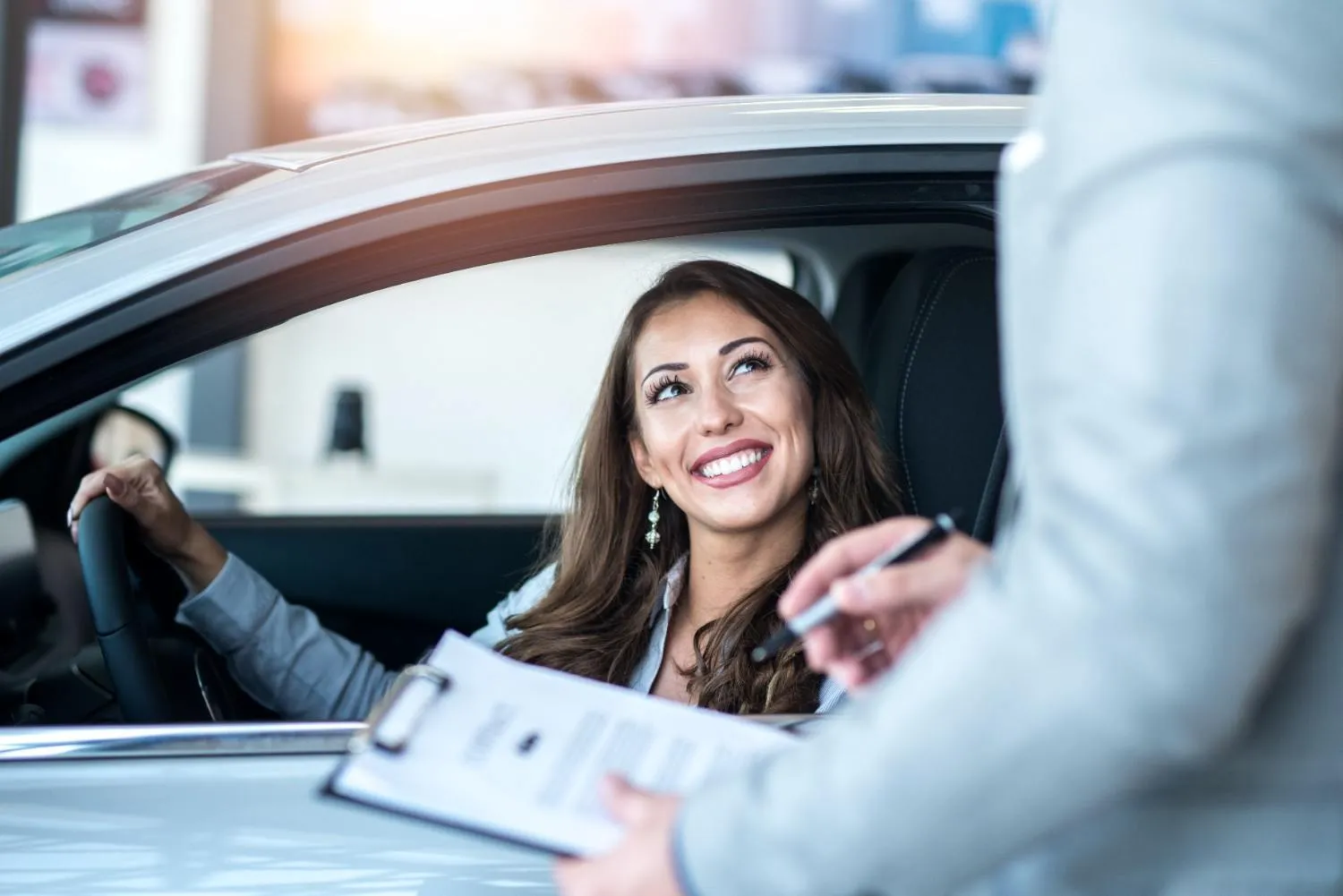 Driver going through her policy details in the car